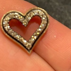 Rose gold and diamond pendant with black around the diamonds.